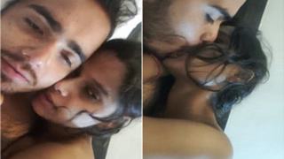 Indian desi couple shares a passionate kiss in a bedroom setting