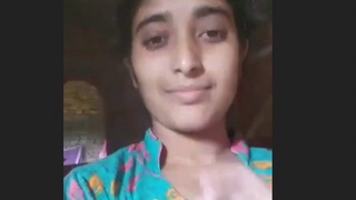Watch a stunning brunette show off her pussy in a village