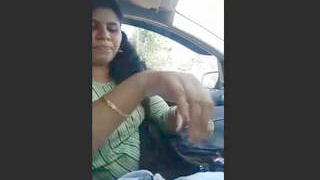 Busty Indian babe sucks off a guy in a car
