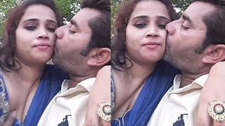 Husband films and enjoys romantic smooch with wife in park
