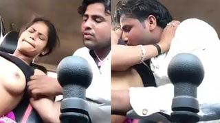 Desi couple indulges in some steamy boob play in a car
