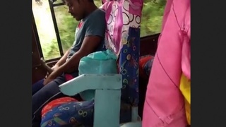 A gay man indulges in a solo masturbation session on a bus, with nearby girls watching and recording
